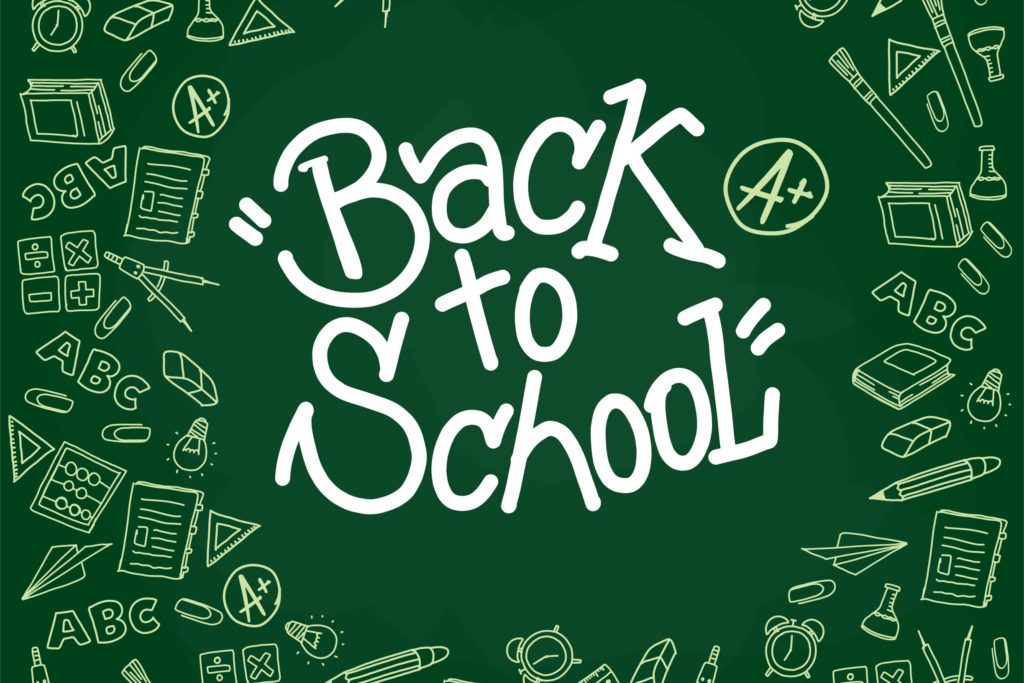 “Back to School” written on a chalkboard surrounded by school-related pictures.