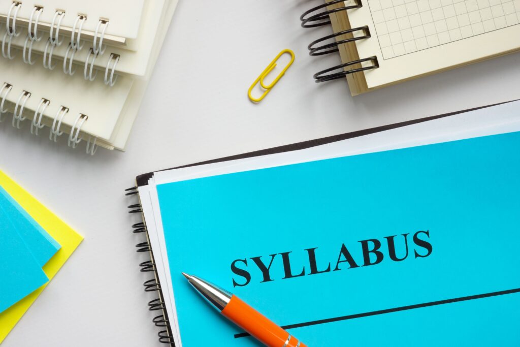 Syllabus educational plan and papers on a desk.