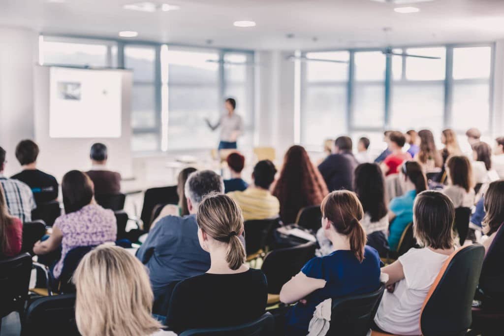 Large group of adults listening to a presentation.