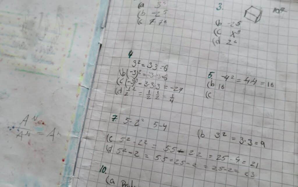 An 8th-grade math sheet with written equations on it.