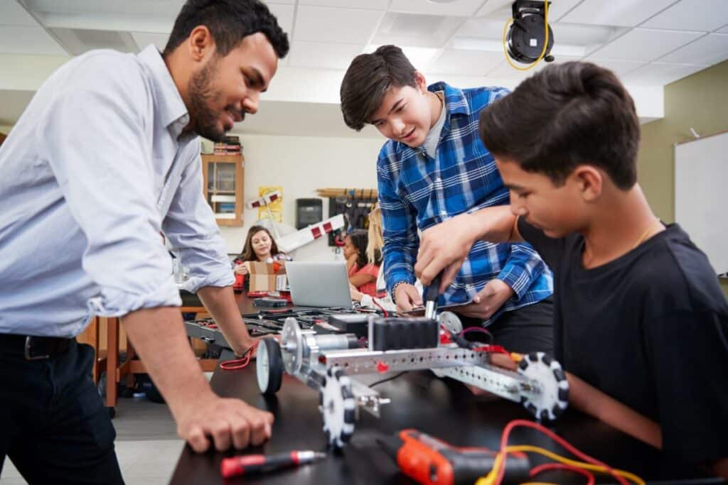 A STEM teacher and his students build a robotic vehicle.