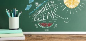 A close-up of a chalkboard with “summer break!” written on it.
