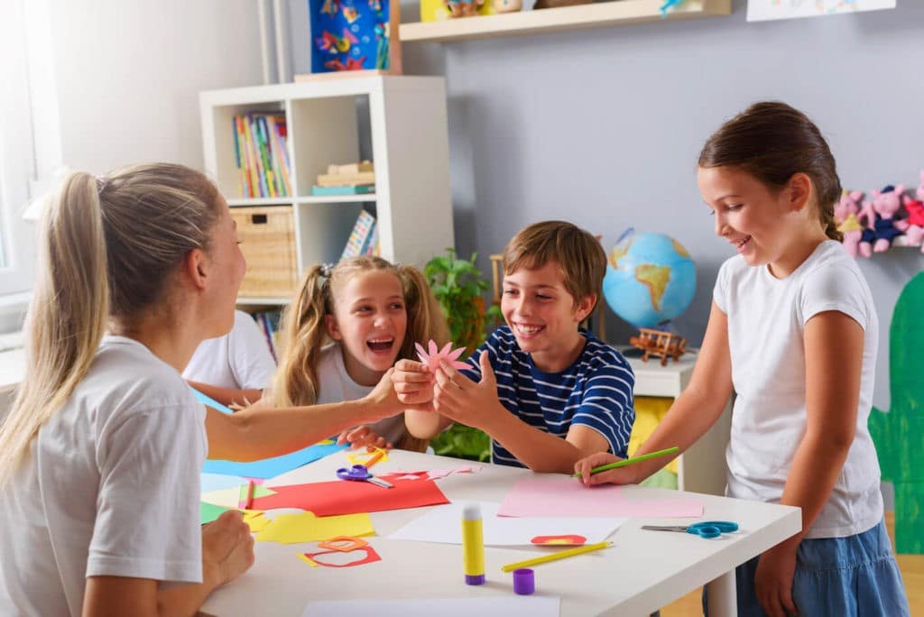 Small group of children having fun together making crafts.
