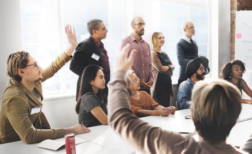 Group of people having a business discussion around a table.