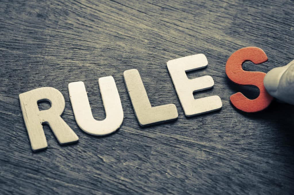 ‘RULES’ spelled out in wooden letters on a table.