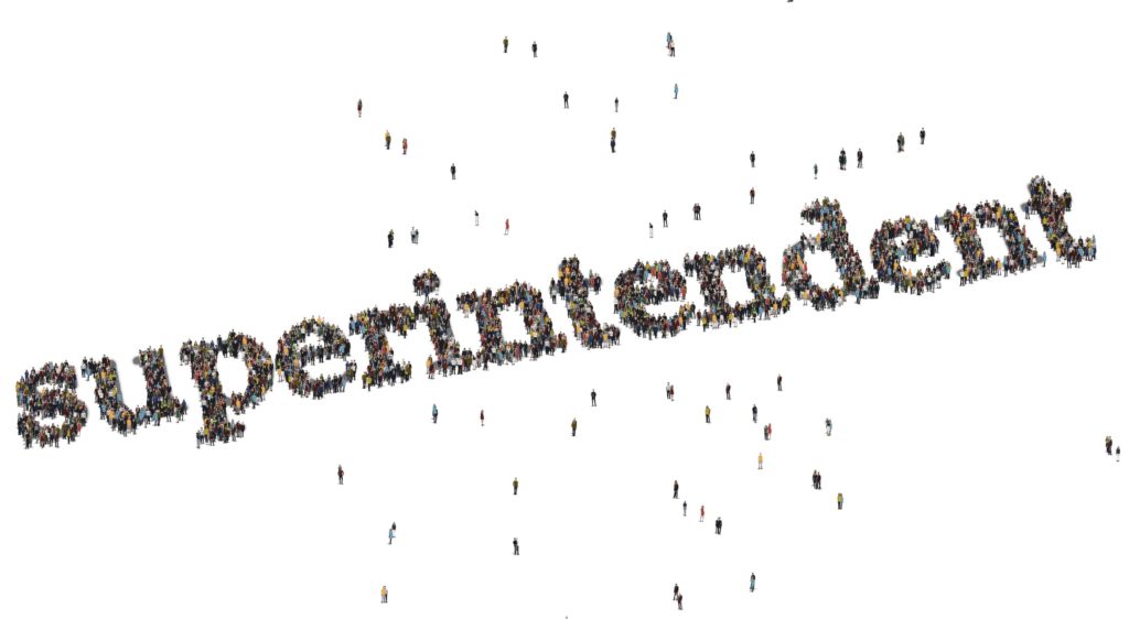 The word “superintendent” is spelled out by a crowd of people.